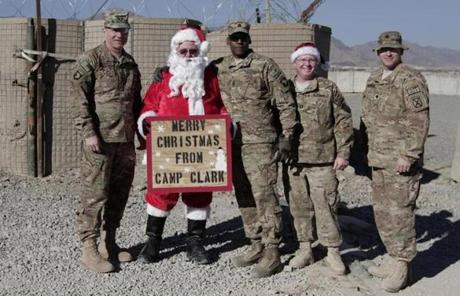 US Major General James C. McConville, left, posed with soldiers (and Santa) at Camp Clark in eastern Afghanistan.
